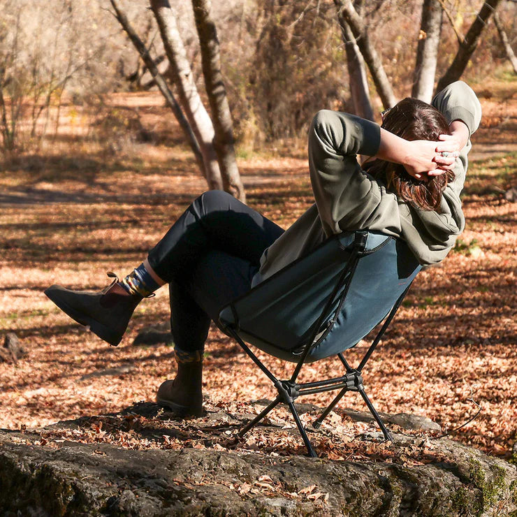 Outdoor adventurer sitting in a Grand Trunk Caddis HD lightweight camp chair