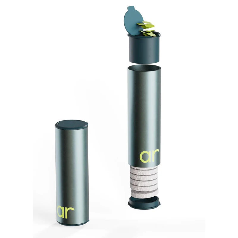 Clean Capsule containing soap flakes and compressed towelettes for portable cleaning on the go