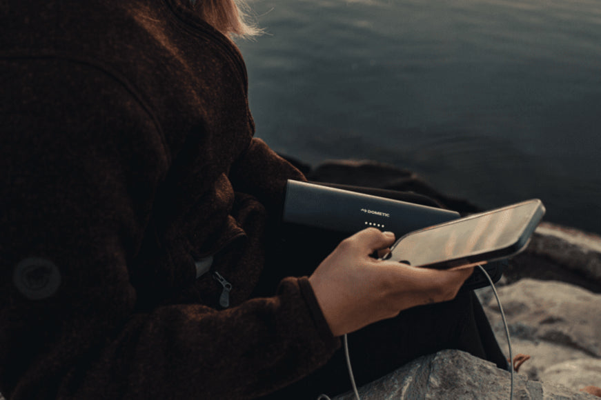 Accessories included with the Dometic PLB15 battery: USB-C to USB-C cable, car cigarette lighter charging cable, user manual, and a color gift box