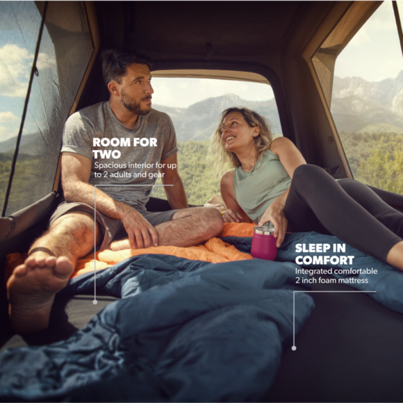 A close-up of the interior space of the rooftop tent, featuring the 3.2 cm high-density foam mattress and anti-condensation mat. Mesh windows on all sides offer ventilation and connection to the outdoors while maintaining privacy.