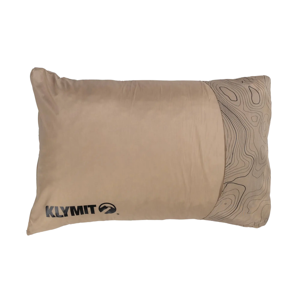 A traveler using the Drift Pillow for neck support during a flight. The compact and supportive design ensures comfort on long journeys, making it an essential travel companion.