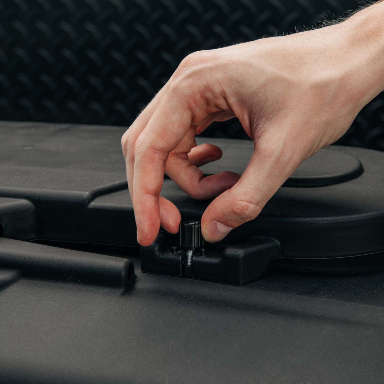 Camco RV propane tank cover installed on an RV, shielding propane tanks from road debris and sun damage.