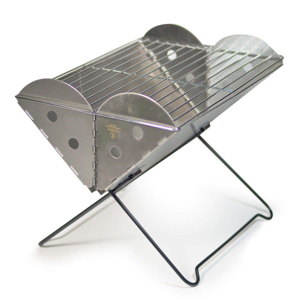 Compact Flatpack portable grill folded to a thickness of approximately 1.1 inches for easy transportation.
