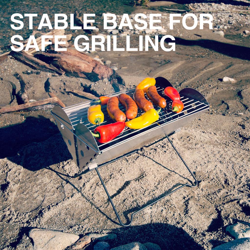 Flatpack portable grill being used for cooking with food on the grates, showing its wind-break sides.