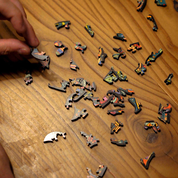 Wooden puzzle pieces shaped like wildlife and outdoor icons in the Timber Wolf Puzzle.