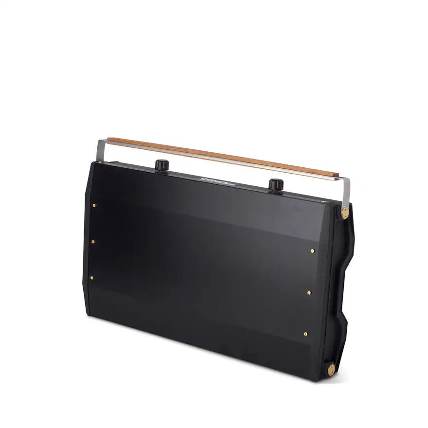 Slim-profile 2-burner camp stove folded with wood-trimmed locking handle for secure transport and storage.