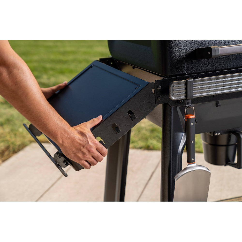 Wood-fired Traeger Woodridge Pro grill with modern outdoor cooking design