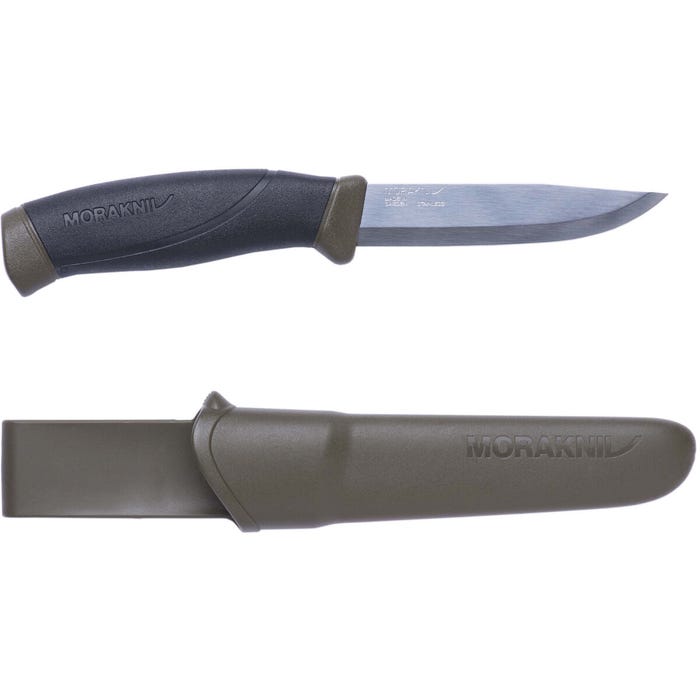 Image of the Morakniv Companion Knife Carbon in Military Green, featuring a 4.1-inch satin-finished carbon steel blade with a clip point design. The knife is displayed alongside its green plastic sheath with a belt clip.