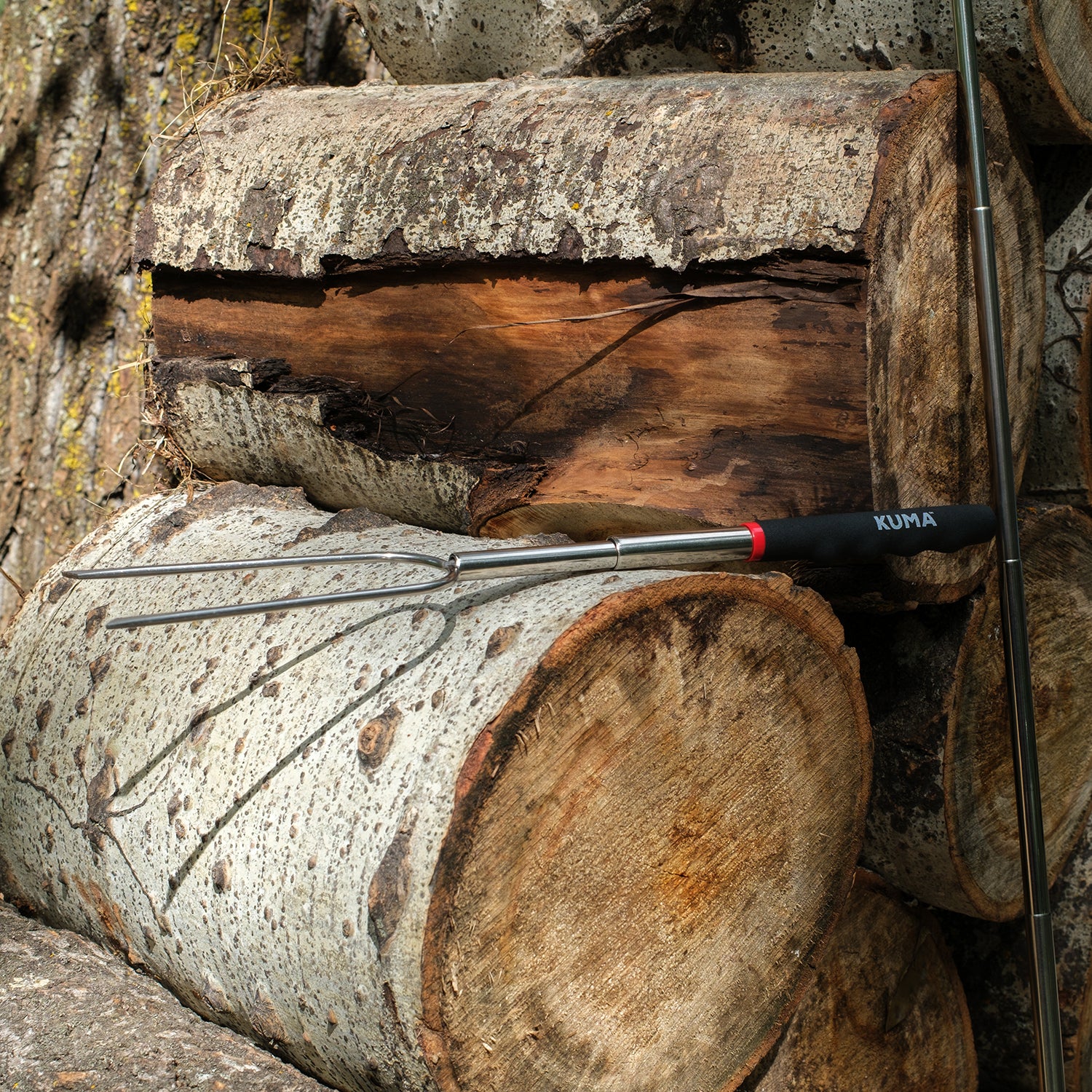 Wooden logs with a Kuma brand tool on top