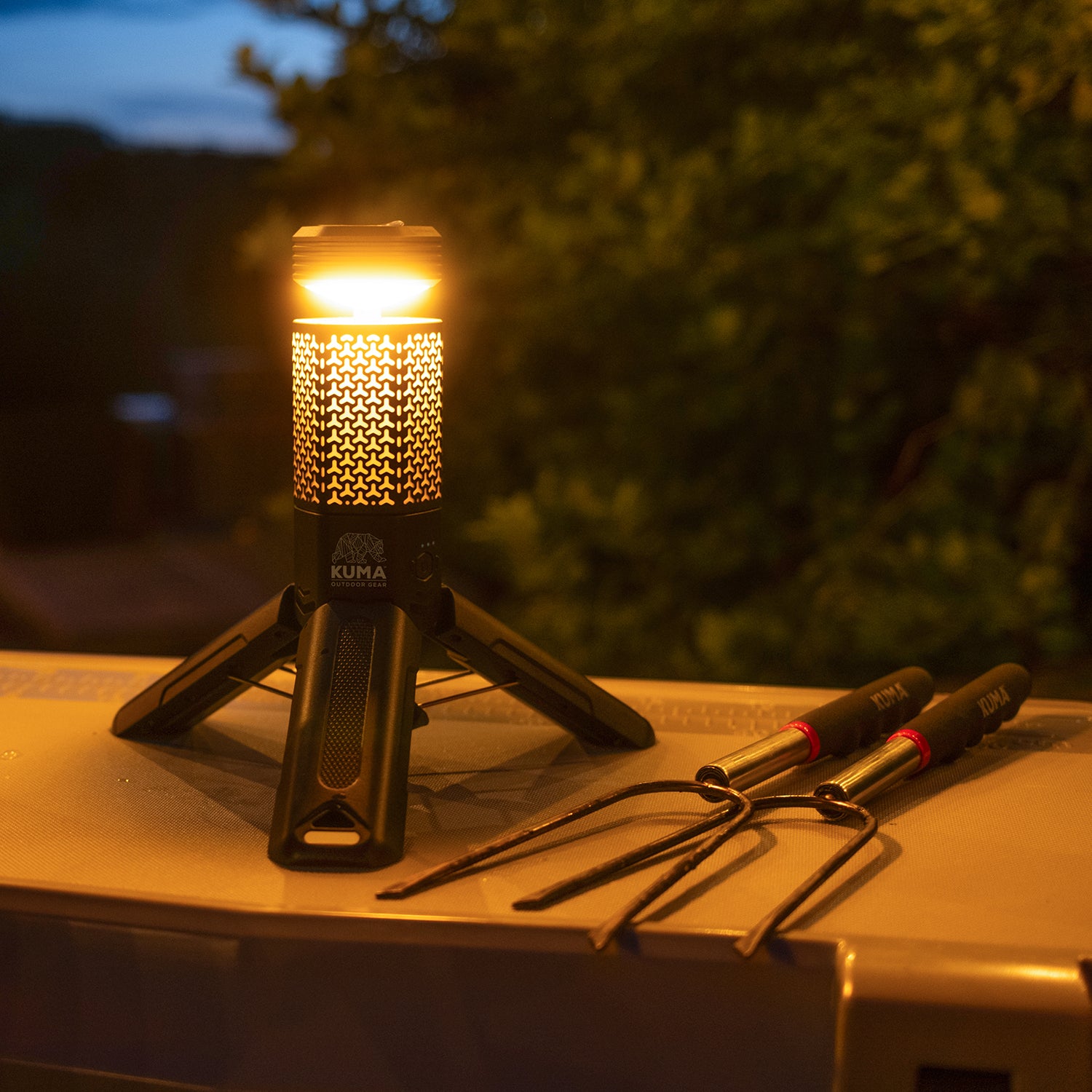 Portable camping stove with a light on a wooden surface outdoors