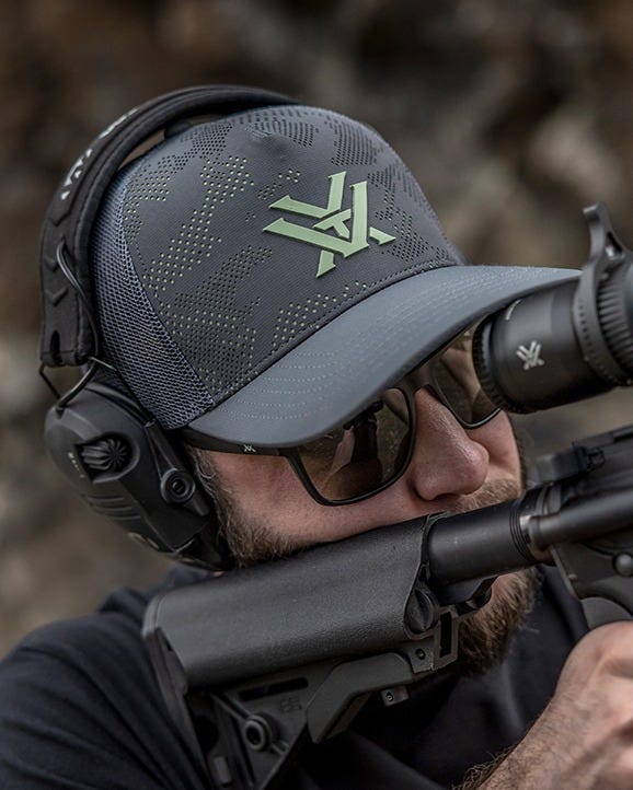 Hunting and shooting lifestyle cap with perforated camouflage front