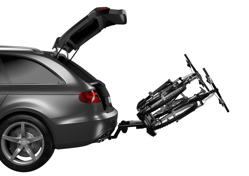 Thule EasyFold XT 2 hitch bike rack demonstrating the foot pedal tilt for easy trunk access.