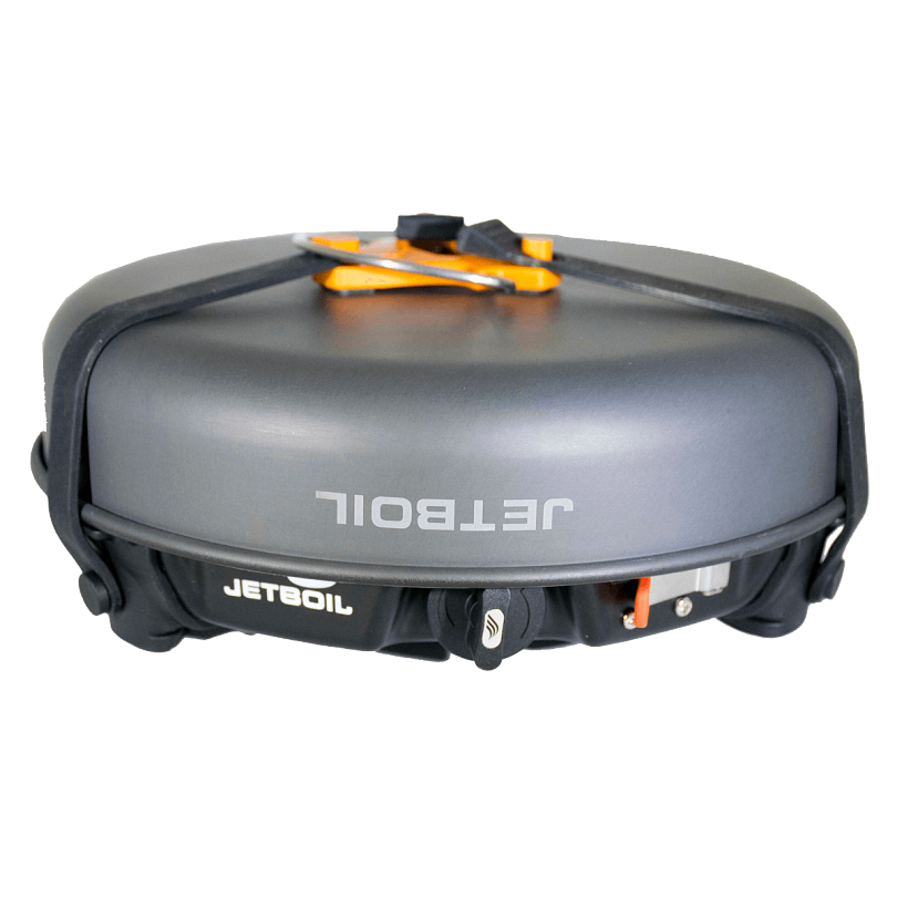 Jetboil HalfGen cooking system boiling water in a ceramic-coated fry pan outdoors.