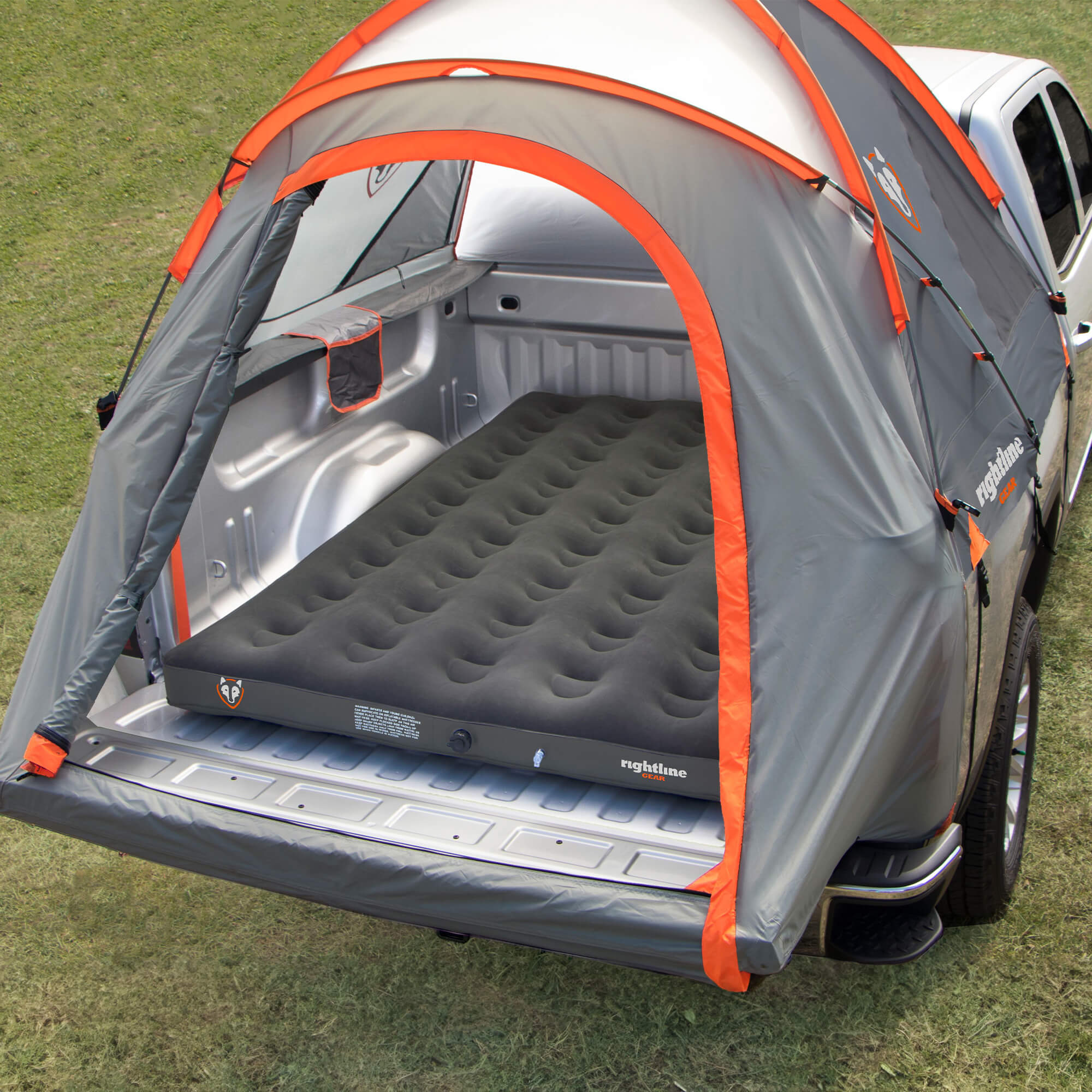 Truck bed air mattress folded up compactly in a stuff sack for easy storage.