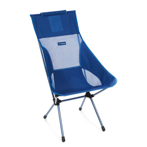 Compact Helinox Sunset Chair packed in a 19 x 5 x 4.5-inch zippered case with a daisy chain handle, emphasizing portability for camping and picnicking.