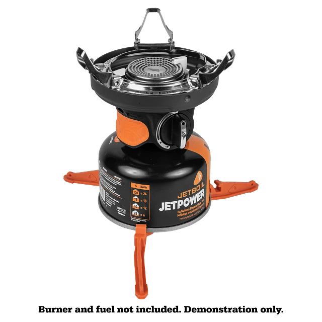 Jetboil Pot Support 2.0 neatly packed and attached to the burner base, showcasing its space-saving feature for easy transport in a backpack.

