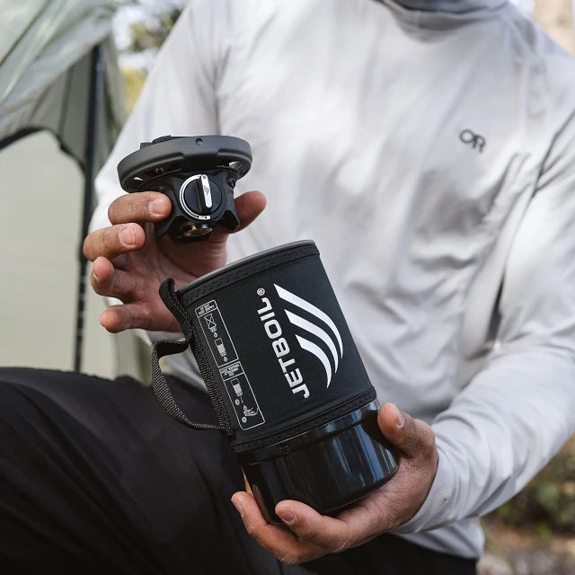 The Jetboil Zip 0.8L alongside compatible accessories like the Hanging Kit 2.0, Pot Support 2.0, Summit Skillet, and 1.5L Ceramic Cook Pot, showing versatility in outdoor cooking.

