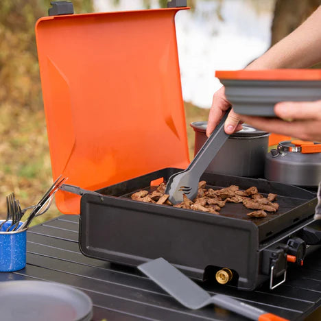 Travel-friendly griddle with carry handle, leveling feet, and secure cover latches