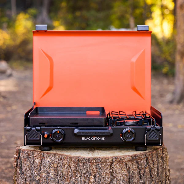 Compact propane griddle with side burner and latching hood for easy transport
