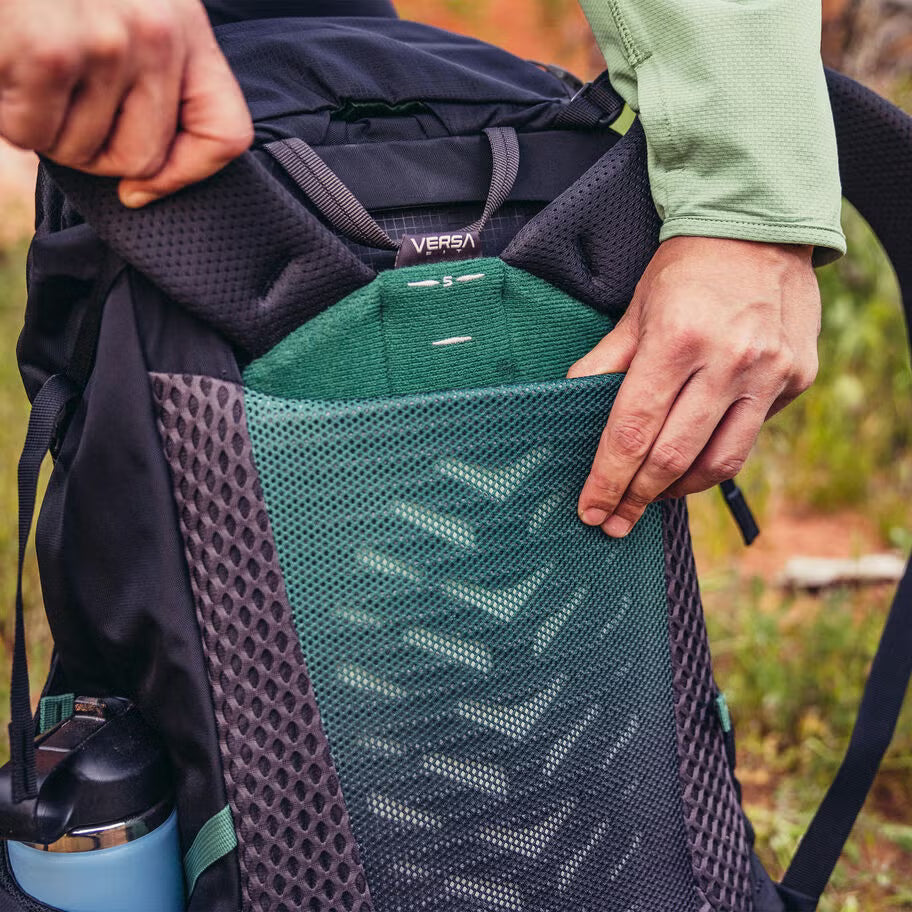 Durable backpacking backpack with sleeping bag compartment and trekking pole attachment