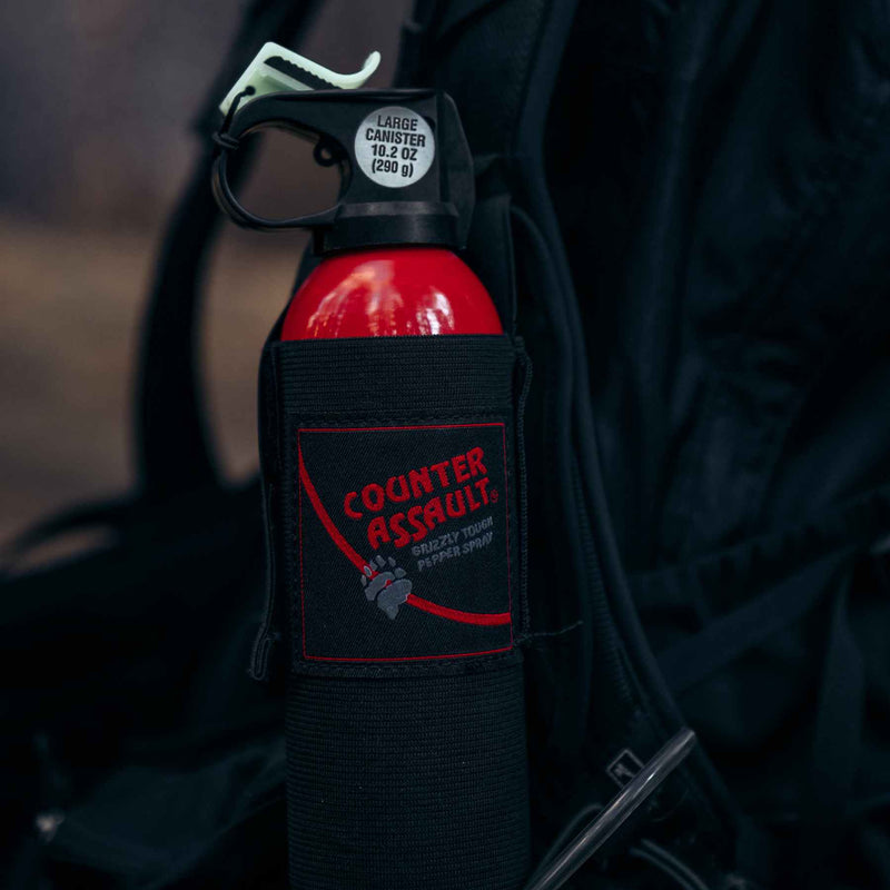 Sturdy nylon belt holster securely holding the 10.2 oz. bear spray canister for easy access during outdoor activities