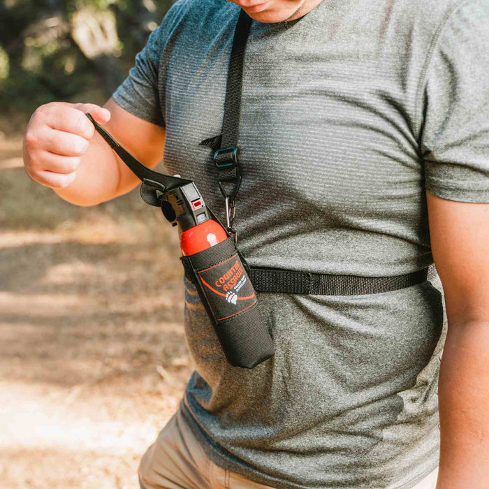 Chest-mounted bear spray holster for hiking and hunting