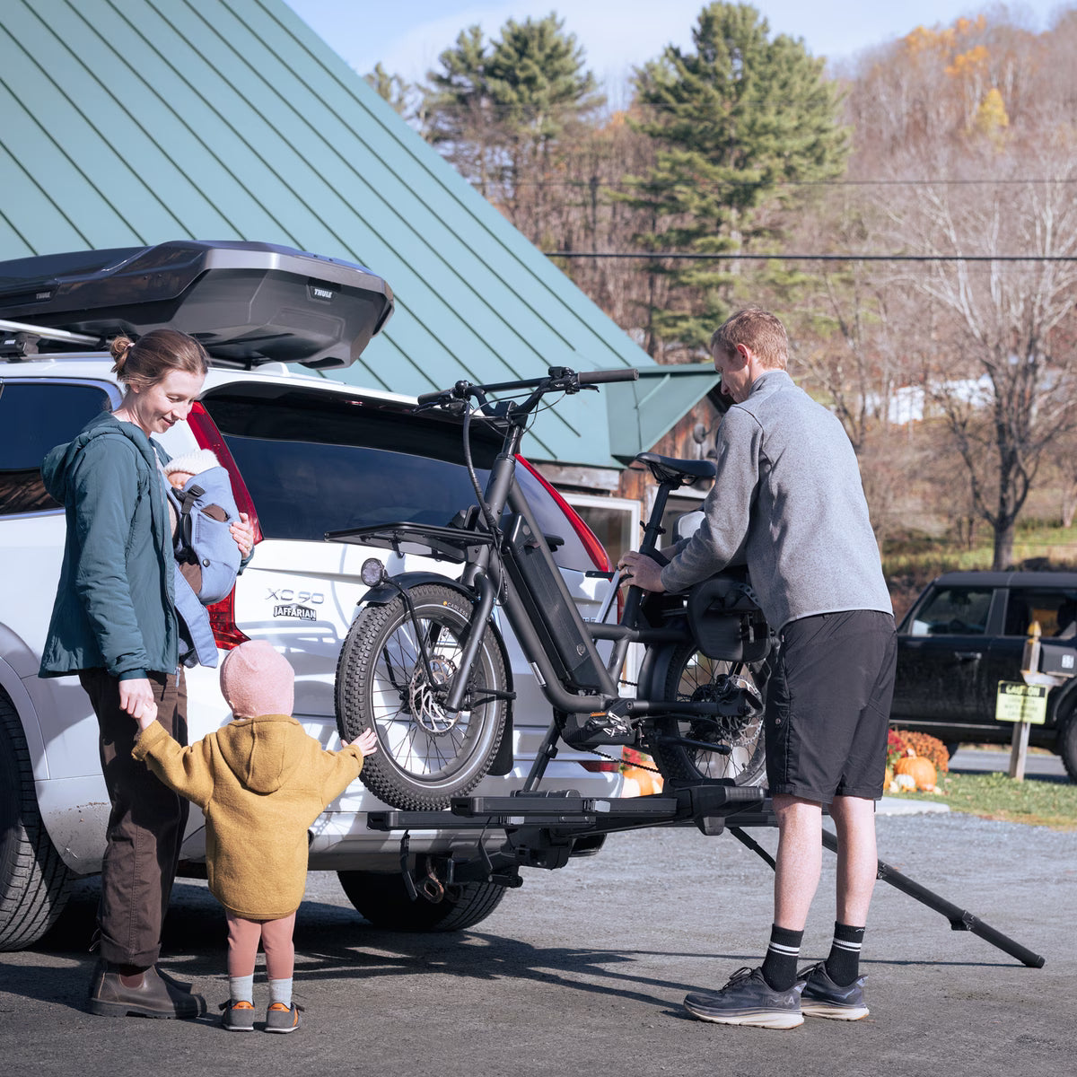 Foldable Thule Vero platform rack compactly stored against vehicle
