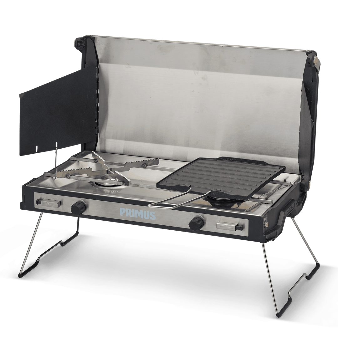 Elegant wood-trimmed 2-burner gas stove with stainless steel body and fold-out legs, designed for gourmet cooking at the campsite