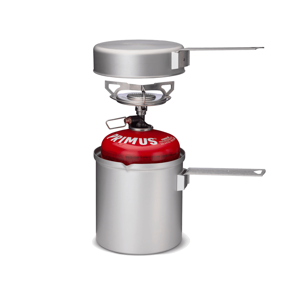  Compact all-in-one Essential Trail Kit with stove, pot, frying pan lid, and handles assembled for 1-2 person cooking outdoors.