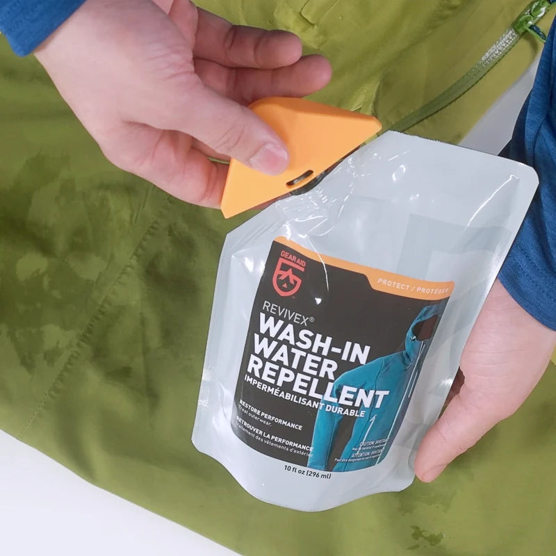 Adding Revivex Wash-In Water Repellent to a washing machine to treat rain gear