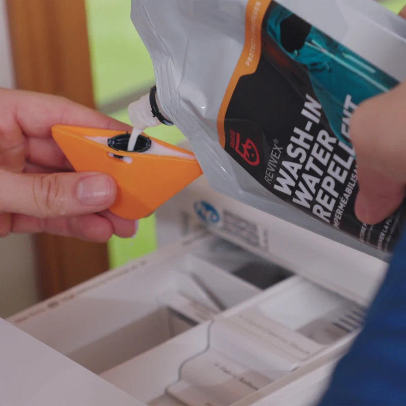 Soaking a softshell jacket in a basin with Revivex Wash-In DWR treatment