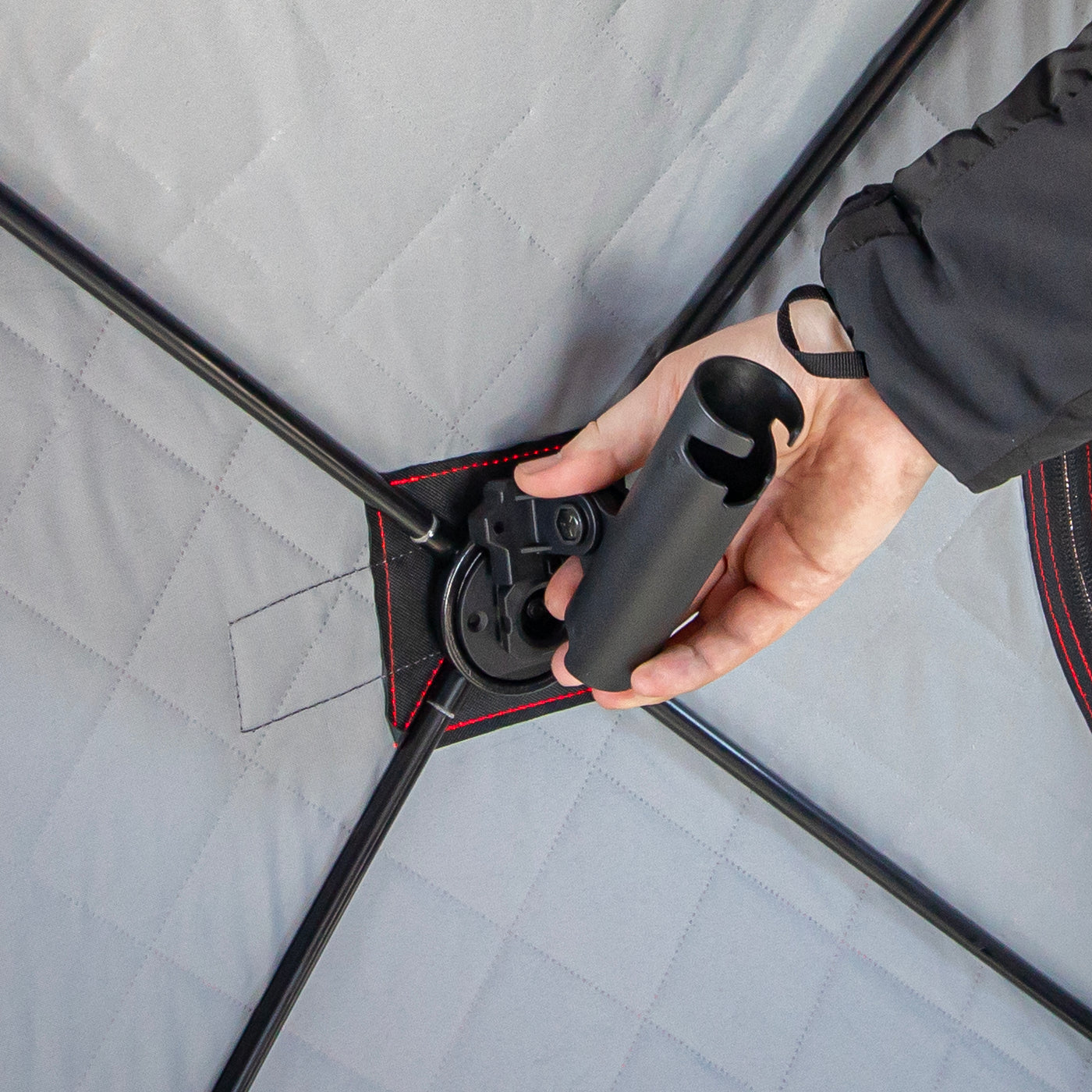 E-Hub rod cradle holding ice fishing rod securely in shelter