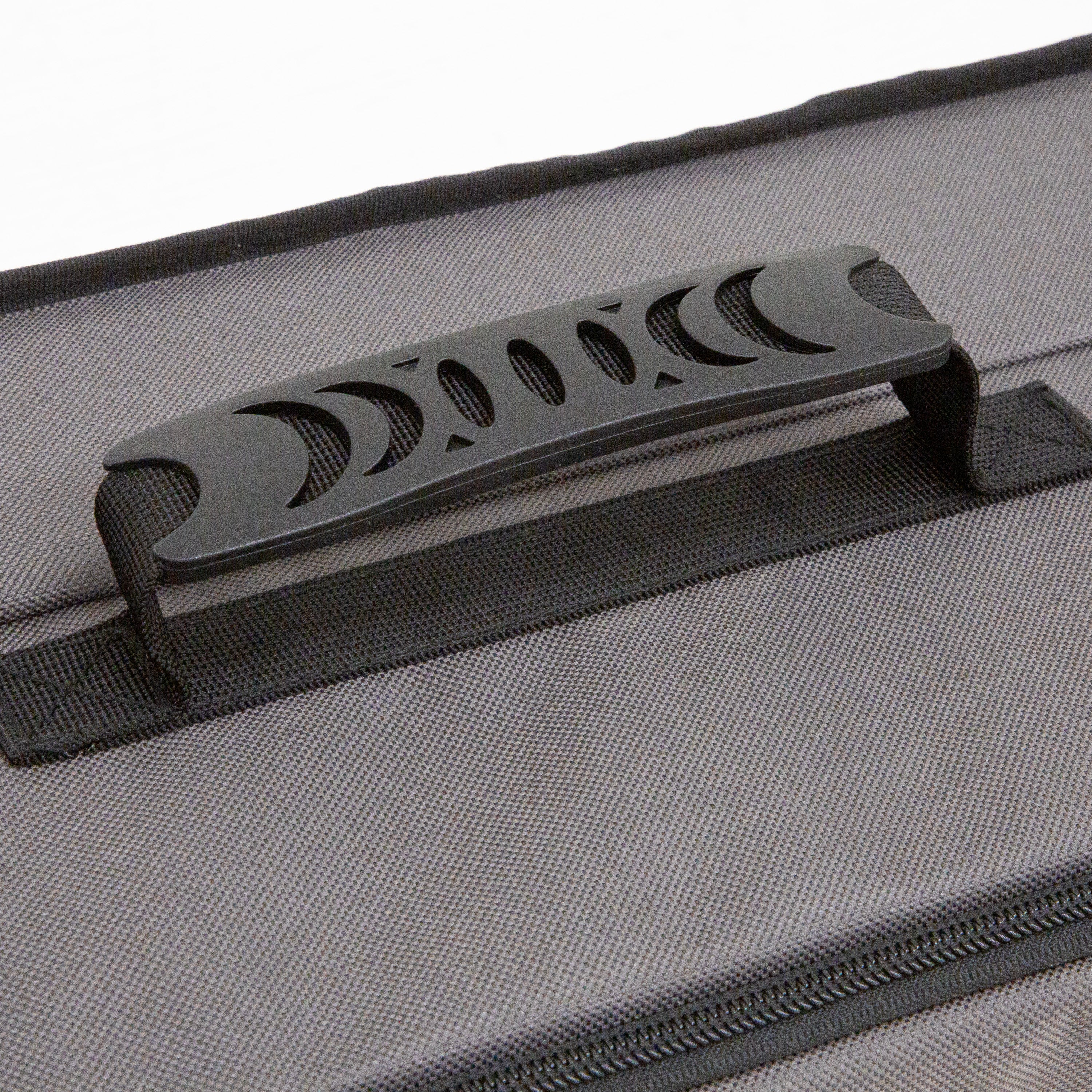 Gray suitcase with a black handle on a white background