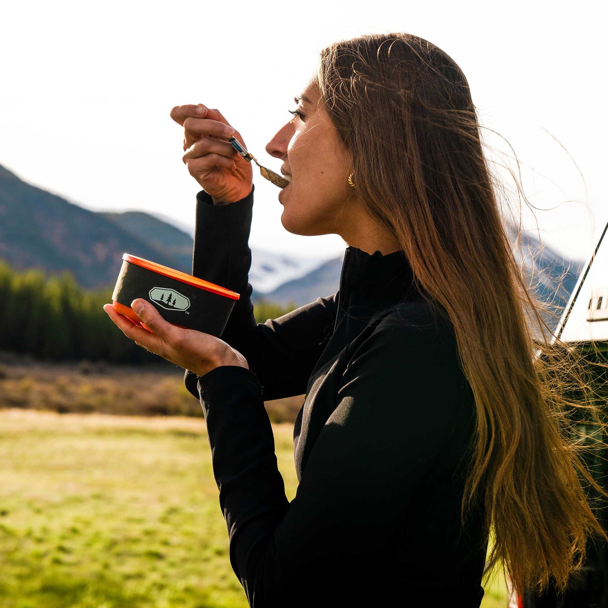 Cookware pot with a folding handle that locks into place for cooking and secures the set for transport