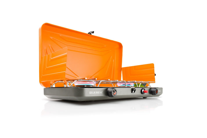 Cookware pot with a folding handle that locks into place for cooking and secures the set for transport.