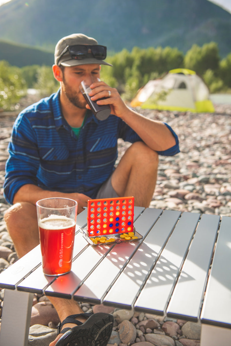 GSI Outdoors Backpack 4 In-a-Row game board opened with colored playing pucks.