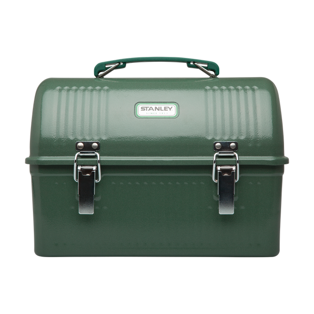 A green Stanley tool box with a top handle, ribbed metal body, two silver latches, and a white Stanley logo badge on the front, photographed on a plain white background.
