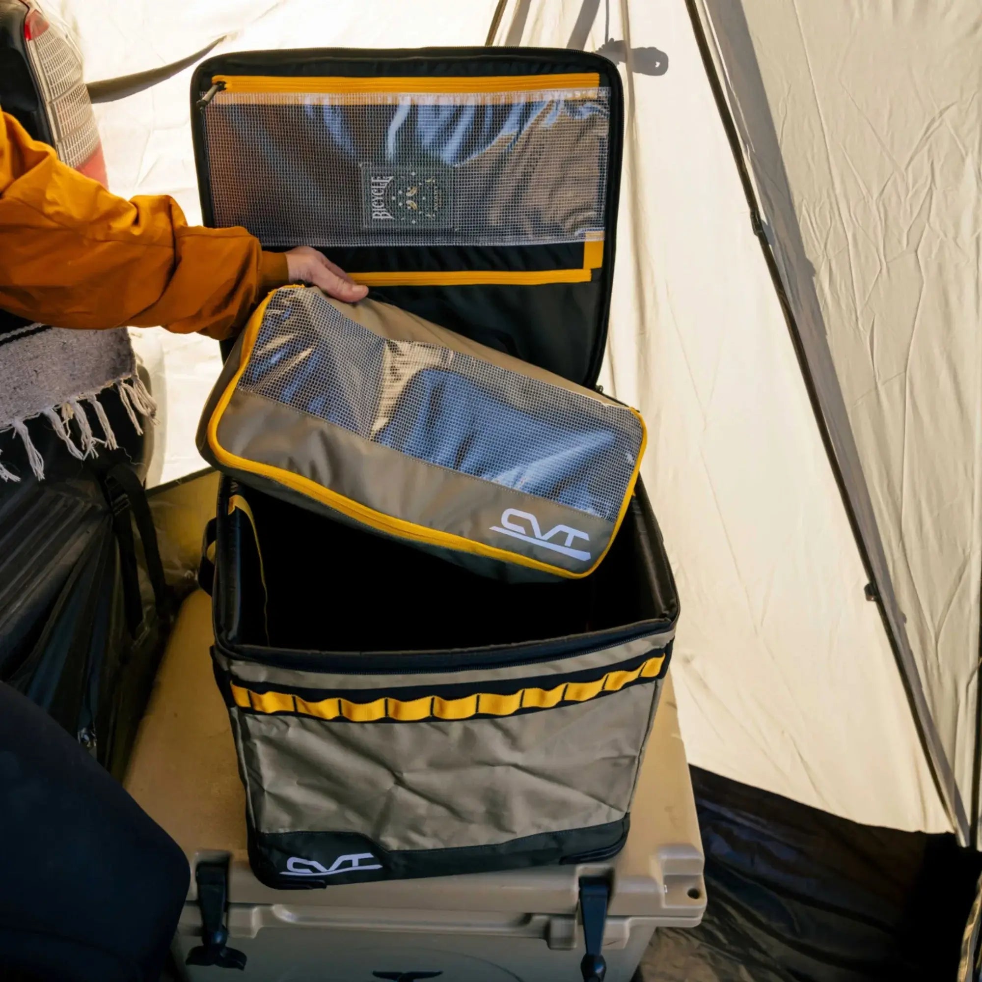 A camper or hiker unpacking CVT Camping Cubes at a campsite, showing their ease of use and organizational benefits for outdoor trips.