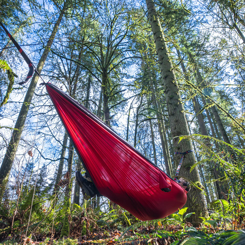 Tree-safe camping hammock with wide straps approved for protected outdoor areas