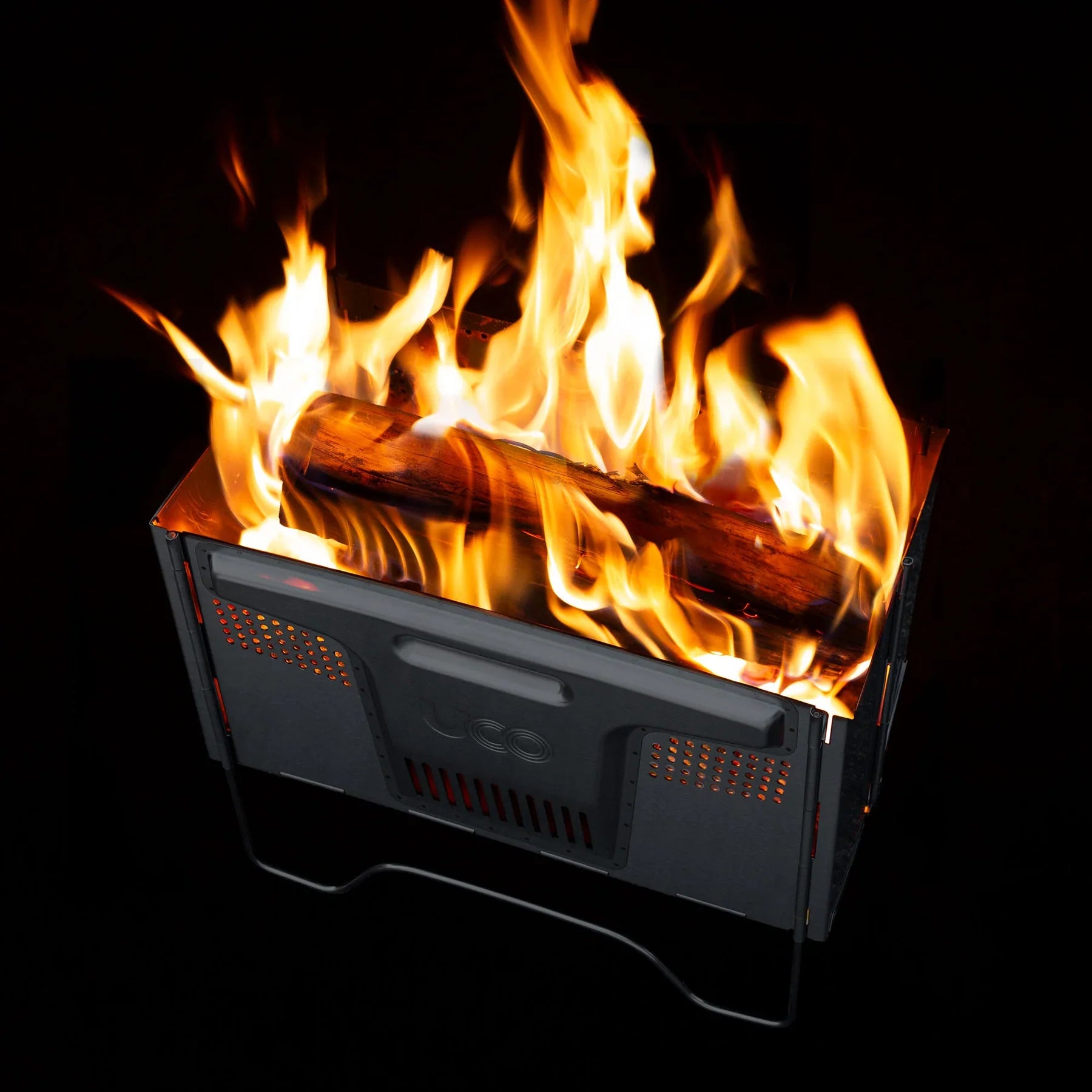 Flatpack Smokeless Firepit glowing in outdoor setting, providing warmth and visibility with radiant heat vents and smokeless burn