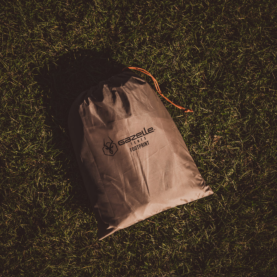 G6 Gazebo Footprint with tack down stakes – The footprint laid out with included stakes for securing it in place.
