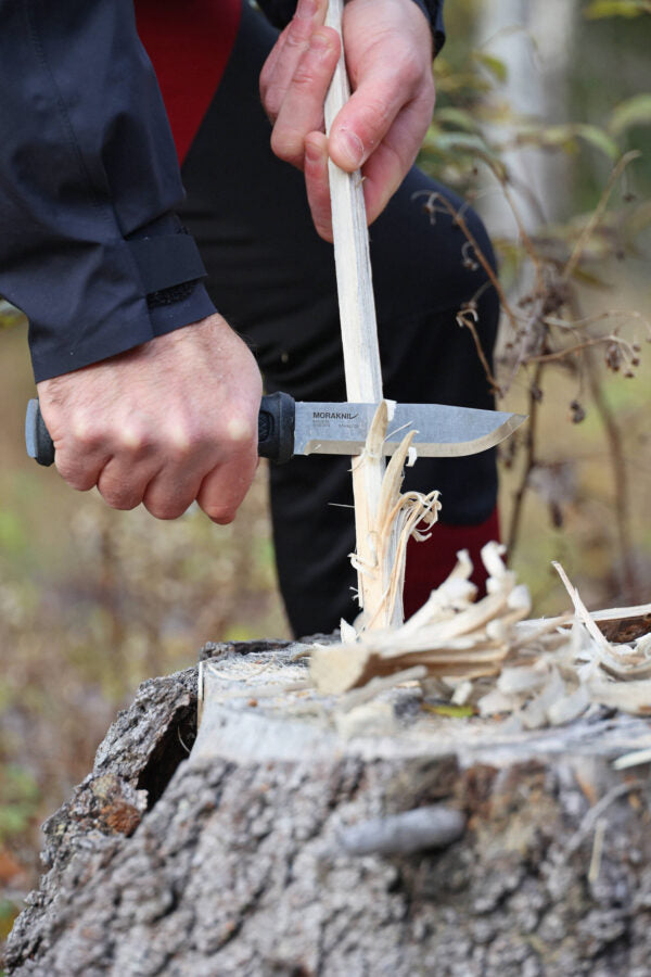 Morakniv Garberg knife securely attached to belt with leather sheath, offering quick access for outdoor adventurers