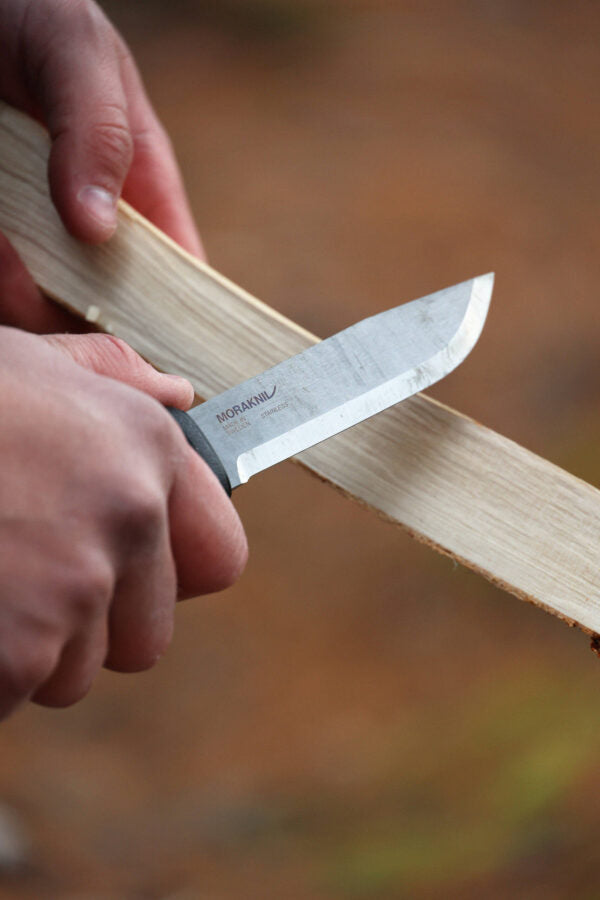 "Close-up of Morakniv Garberg knife with 3.2mm thick Swedish stainless steel blade, featuring finger guard and ergonomic handle for precision cuts