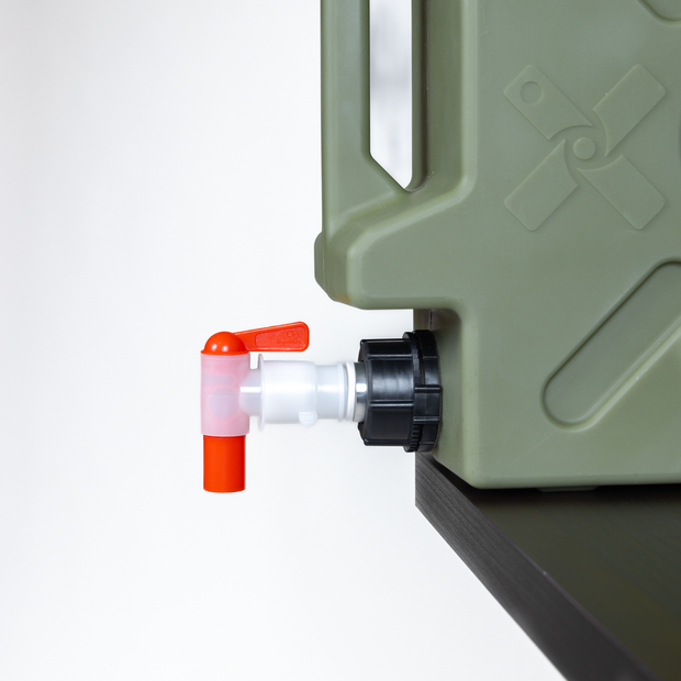 Green plastic container with a red and white valve on a white background