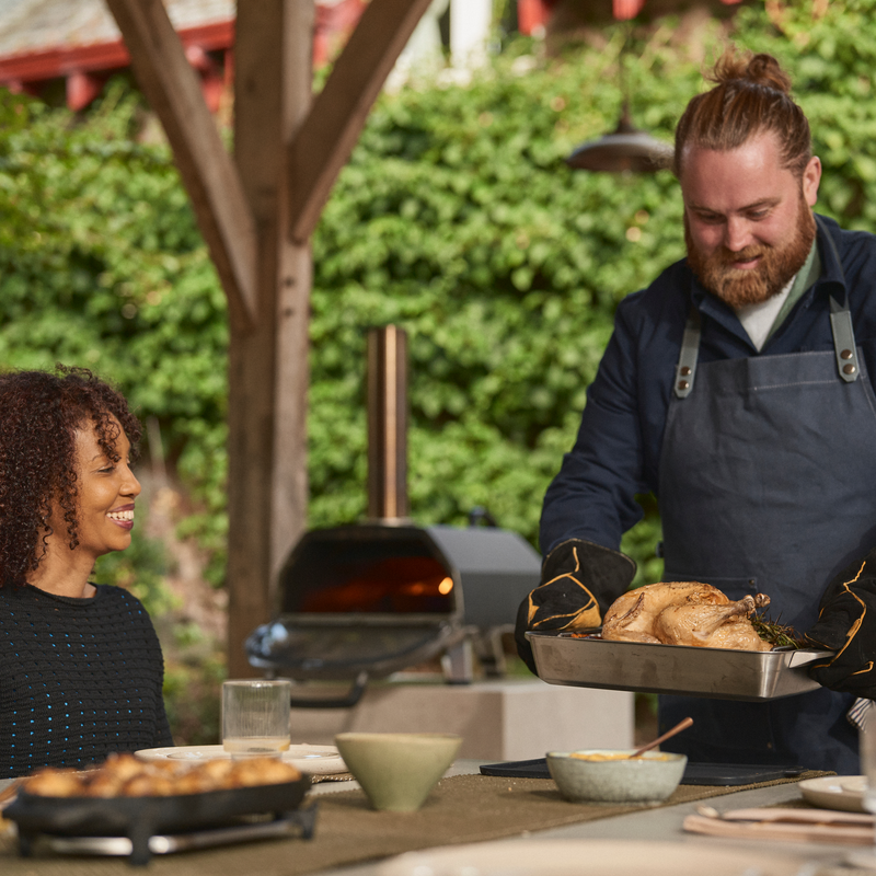 Heavy-duty carbon steel outdoor pizza oven with stainless steel frame and insulated shell