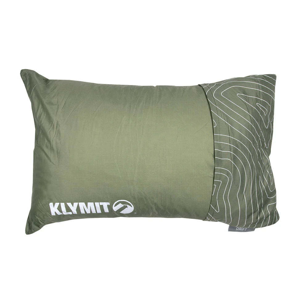 A compact Drift Pillow with a durable, water-resistant outer shell, neatly packed with a strap for easy travel. The pillow is designed for portability and versatility, perfect for on-the-go comfort.