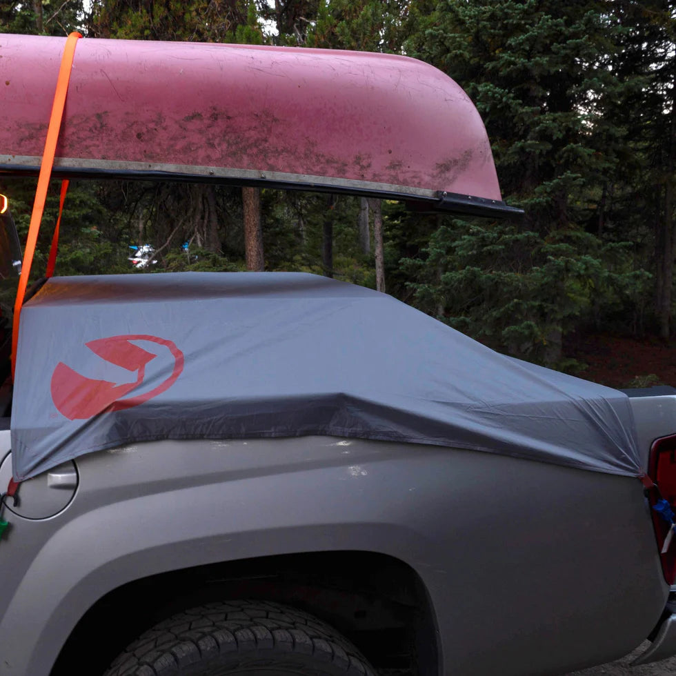 Roamer Throw Tarp neatly folded and packed into a compact carrying bag, demonstrating its lightweight and travel-friendly design.