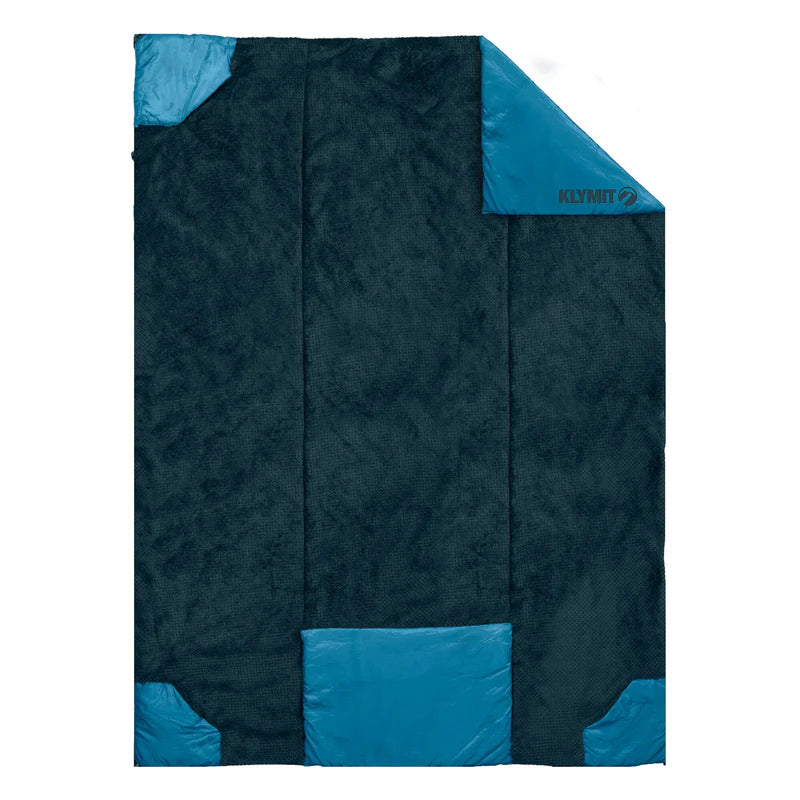 Person wrapped in the Versa Luxe Blanket, enjoying warmth and comfort with high-loft fleece inside.