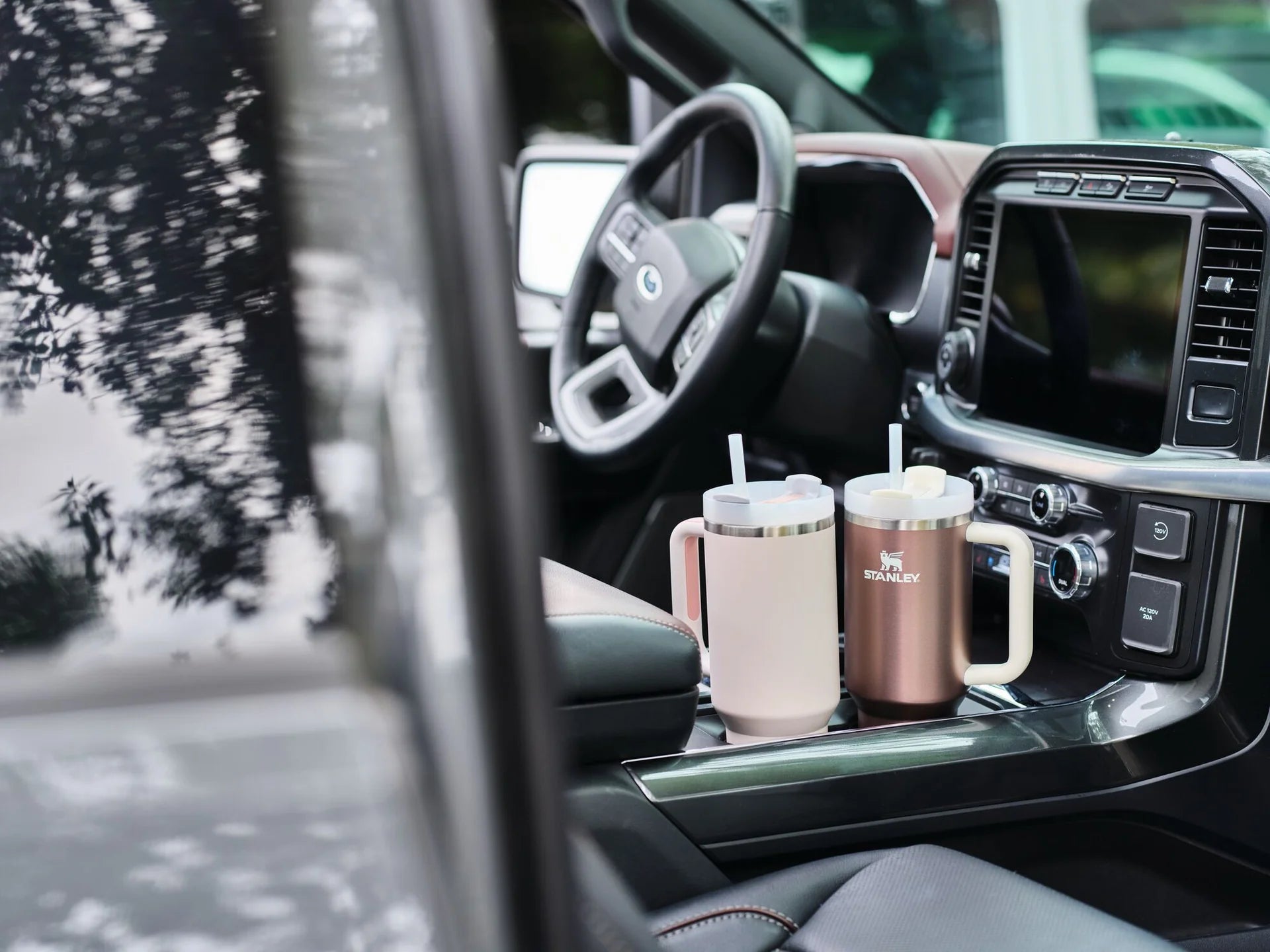 Ergonomic travel tumbler with narrow base to fit most cup holders