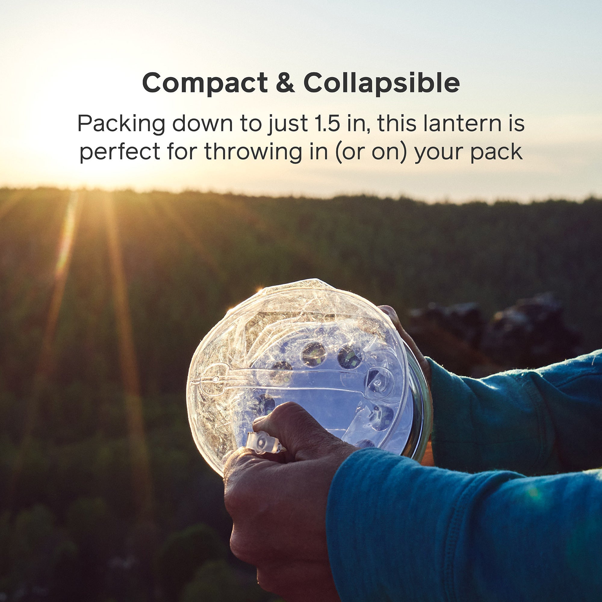 Compact lantern held by a person with scenic background